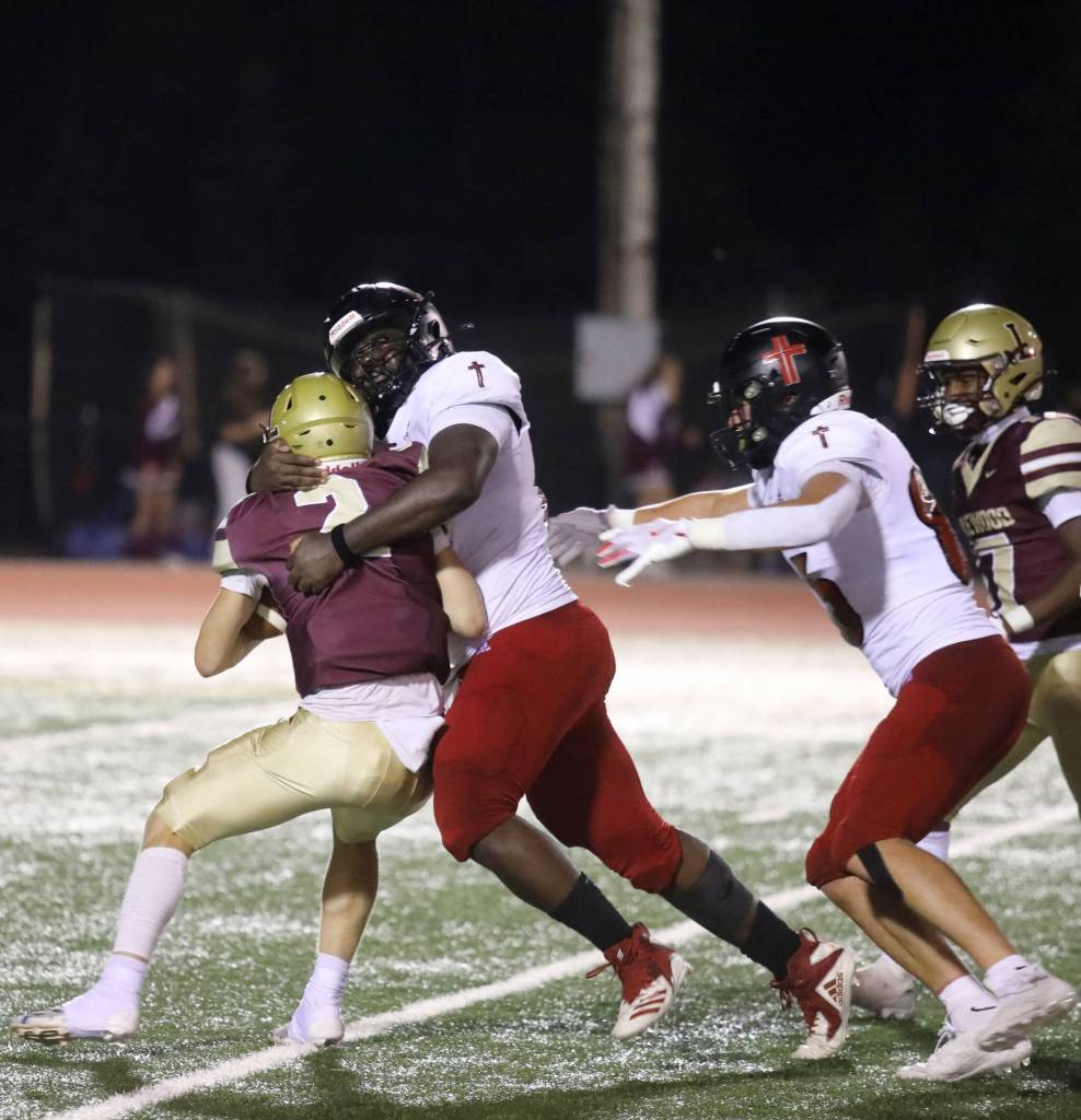 Archbishop Murphy junior defensive lineman Hakeim Smalls wraps up Lakewood senior quarterback Nash Espe during the Archbishop Murphy-Lakewood football game at Lakewood High School on Sept. 6, 2024. The Wildcats won 48-24. (Taras McCurdie / The Herald)