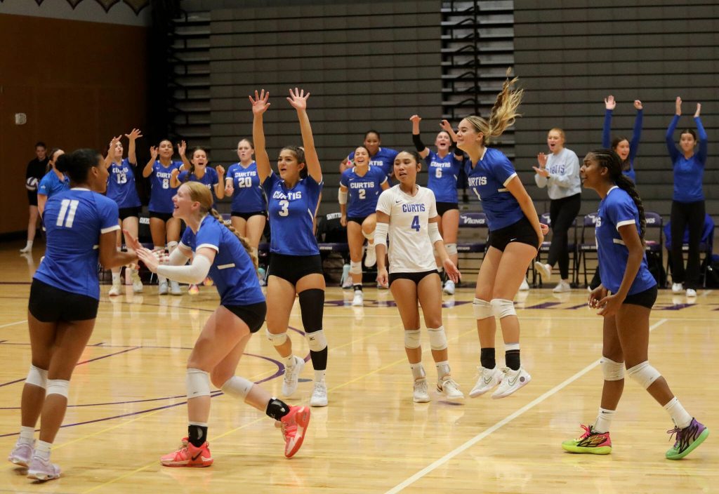 Curtis High School players celebrate after scoring a point against Lake Stevens in the Vikings season opener in Lake Stevens, Wash., on Sept. 11, 2024. Curtis won all three sets: 25-19, 25-20 and 25-18. (Taras McCurdie / The Herald)