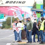 Members of the Boeing Machinists union picket at the intersection of Kasch Park Road and Airport Road on Friday, Sept. 13, 2024, in Everett, Washington. (Michael Henneke / The Herald)