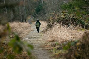 A hiker heads out to the Snohomish River along the trail that leads from the parking lot Wednesday, Dec. 14, 2022, at Bob Heirman Wildlife Park at Thomas’ Eddy in Snohomish, Washington. (Ryan Berry / The Herald)
