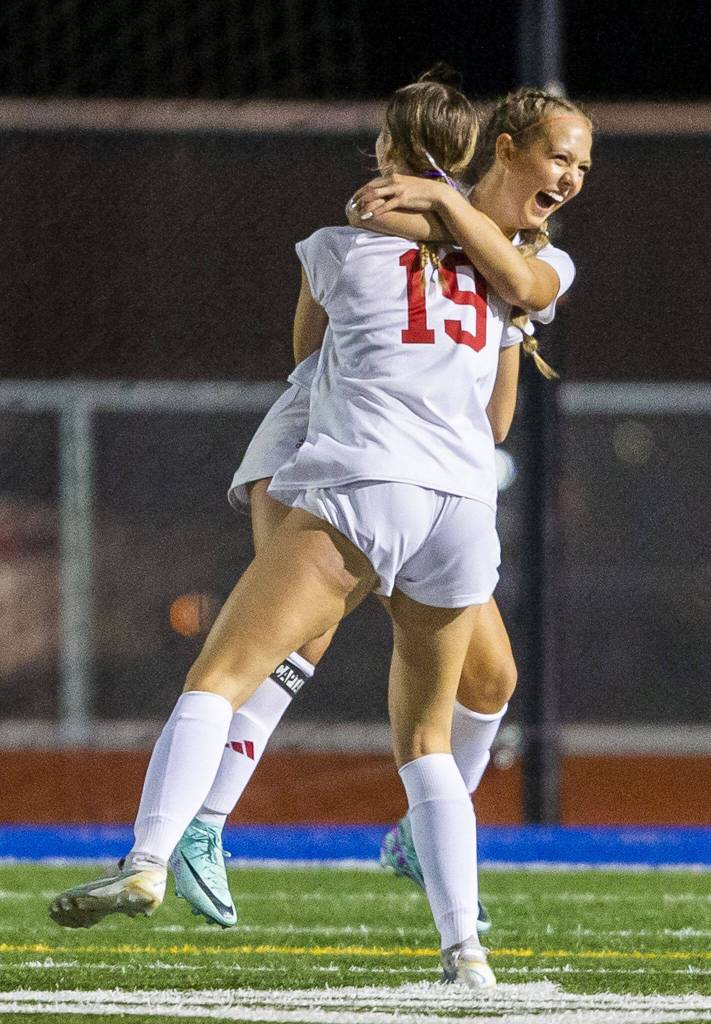 Archbishop Murphys Chloe McCoy is hugged by teammate Julianne Buchan after scoring during the game on Tuesday, Sept. 17, 2024 in Shoreline, Washington. (Olivia Vanni / The Herald)