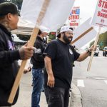 Matt Saldivar, a lead mechanic at Boeing for 5 years, smiles while picketing with other Boeing workers on strike on Monday, Sept. 16, 2024 in Everett, Washington. (Olivia Vanni / The Herald)