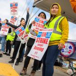 Nory Hang, right, watches cars pass by while picketing with fellow Boeing workers on strike along Airport Road on Monday, Sept. 16, 2024 in Everett, Washington. (Olivia Vanni / The Herald)