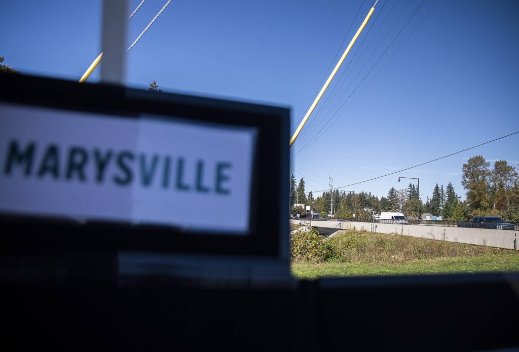 Cars drive along State Avenue across a new culvert that was a part of the project on Tuesday in Marysville. (Olivia Vanni / The Herald)