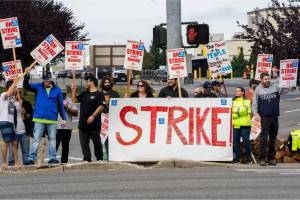 Workers with picket signs outside the Boeing manufacturing facility during the strike in Everett. (M. Scott Brauer/Bloomberg)
