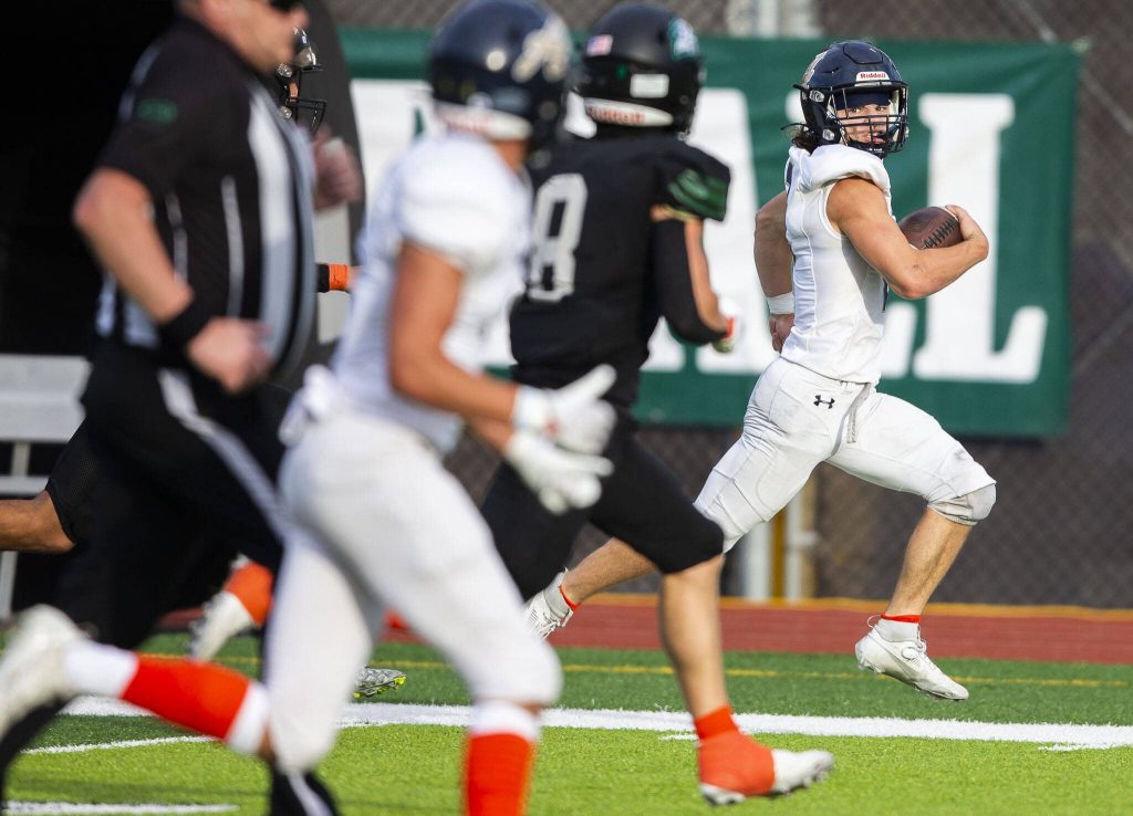 Arlingtons Chase Deberry runs down the field with the ball during the game against Jackson on Friday, Sept. 20, 2024 in Everett, Washington. (Olivia Vanni / The Herald)