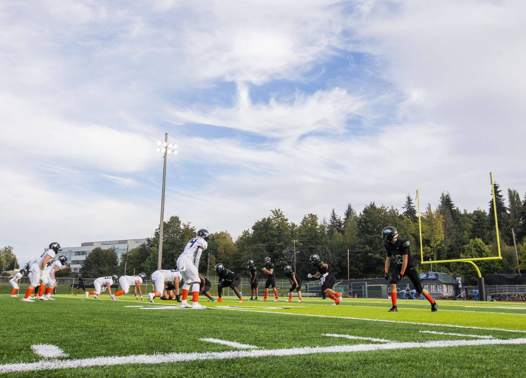 Arlington and Jackson players lineup for the snap during the game on Friday, Sept. 20, 2024 in Everett, Washington. (Olivia Vanni / The Herald)