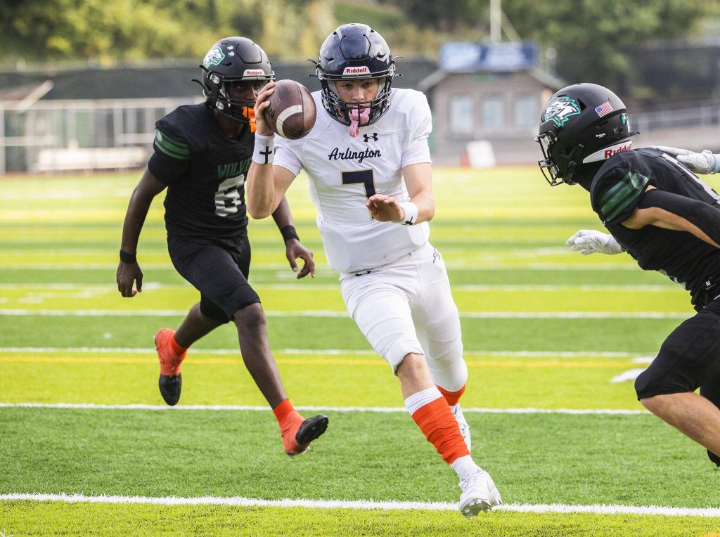 Arlingtons Leyton Martin runs the ball into the end zone for a touchdown during the game on Friday, Sept. 20, 2024 in Everett, Washington. (Olivia Vanni / The Herald)