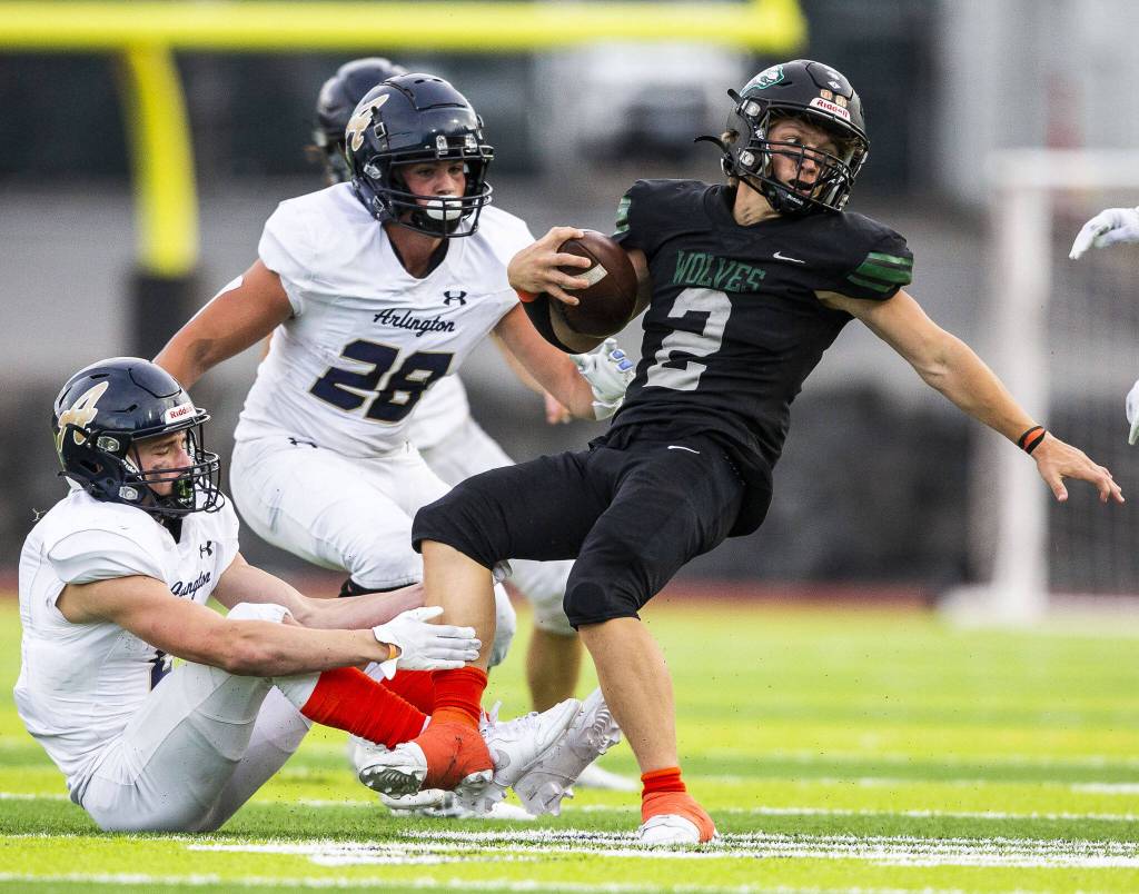 Jacksons Tyler Lykken gets tackled by his leg during the game against Arlington on Friday, Sept. 20, 2024 in Everett, Washington. (Olivia Vanni / The Herald)