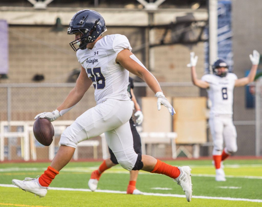Arlingtons Caleb Reed runs the ball into the end zone for a touchdown during the game against Jackson on Friday, Sept. 20, 2024 in Everett, Washington. (Olivia Vanni / The Herald)