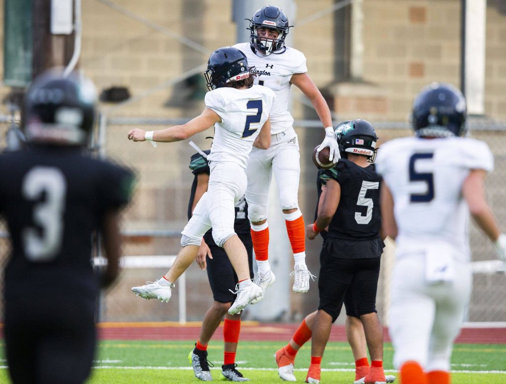 Arlingtons Chase Deberry celebrate his teammate Jake Willis touchdown during the game against Jackson on Friday, Sept. 20, 2024 in Everett, Washington. (Olivia Vanni / The Herald)
