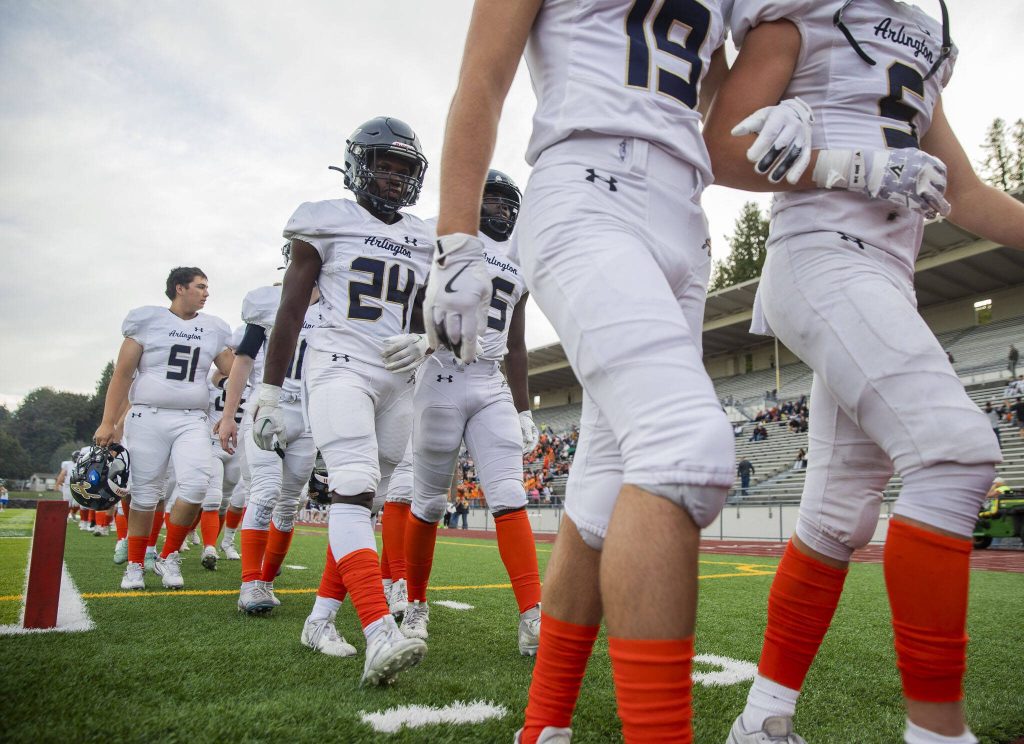 Arlington players walk off the field for half-time during the game against Jackson on Friday, Sept. 20, 2024 in Everett, Washington. (Olivia Vanni / The Herald)