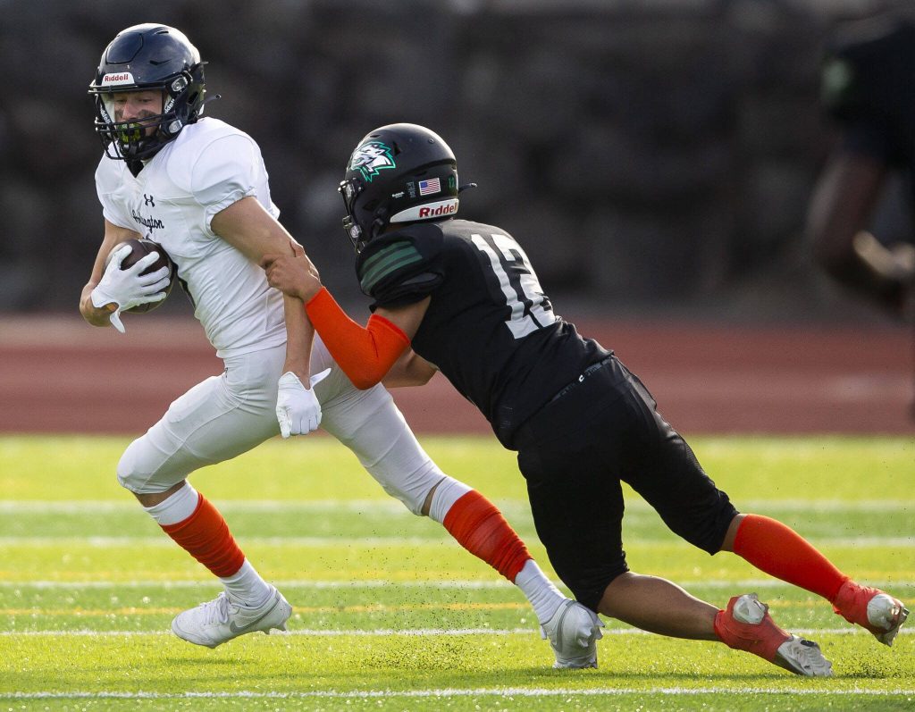 Arlingtons Kaid Hunter is tackled by Jacksons Andy Park during the game on Friday, Sept. 20, 2024 in Everett, Washington. (Olivia Vanni / The Herald)
