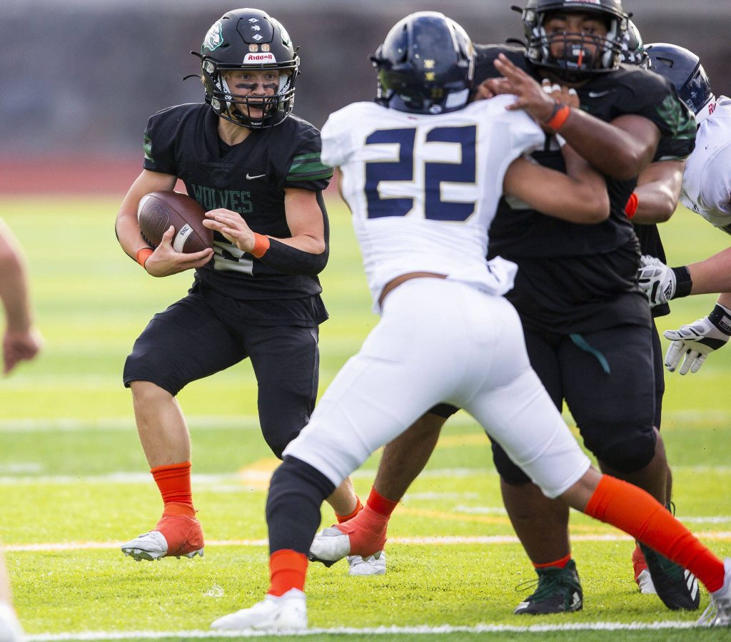 Jacksons Tyler Lykken looks for an opening while running the ball during the game against Arlington on Friday, Sept. 20, 2024 in Everett, Washington. (Olivia Vanni / The Herald)