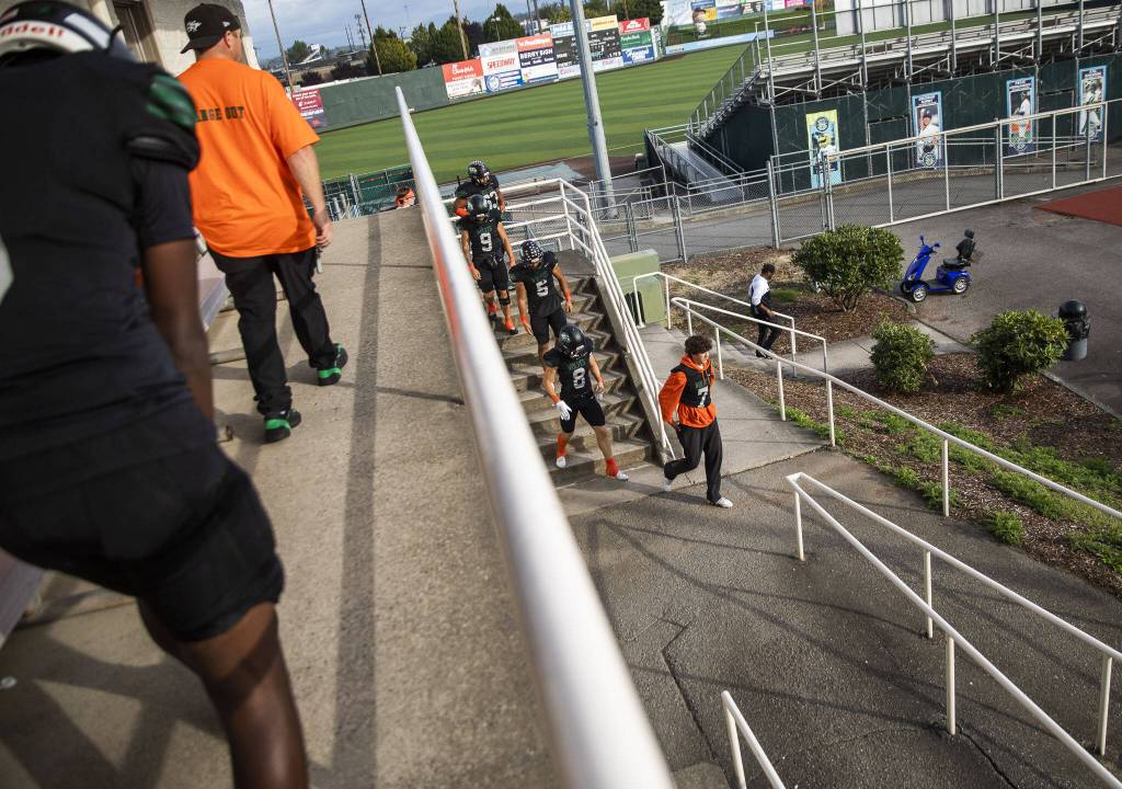 Will Turpin leads his teammates out of the locker room and onto the field for their game on Friday, Sept. 20, 2024 in Everett, Washington. (Olivia Vanni / The Herald)