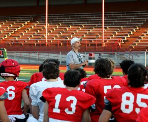 Fourth-year Stanwood High School football coach Jeff Scoma talks with his team at the end of practice at Bob Larson Stadium in Stanwood, Washington on Aug. 30, 2024. (Taras McCurdie / The Herald)