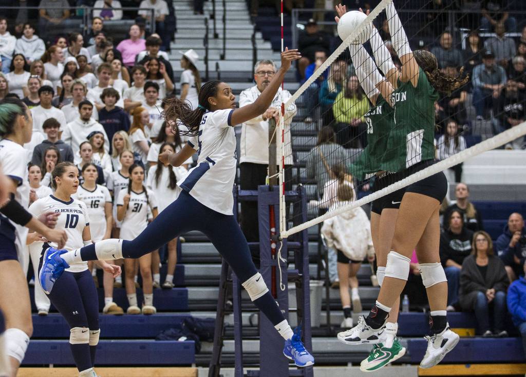Glacier Peaks Hanna Ligons tips the ball over the next during the game against Jackson on Wednesday, Sept. 25, 2024 in Snohomish, Washington. (Olivia Vanni / The Herald)