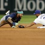 Texas Rangers second baseman Marcus Semien (2) tags out Seattle Mariners shortstop J.P. Crawford (3) during the sixth inning, Saturday, Sept. 21, 2024, in Arlington. (Elias Valverde II / Tribune News Services)