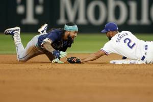 Texas Rangers second baseman Marcus Semien (2) tags out Seattle Mariners shortstop J.P. Crawford (3) during the sixth inning, Saturday, Sept. 21, 2024, in Arlington. (Elias Valverde II / Tribune News Services)