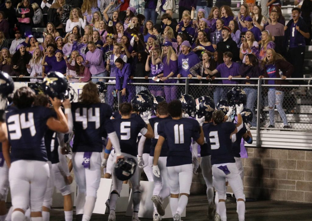 Arlington High School football players celebrate with fans after beating Kamiak 52-7 in a Wesco 4A game at John C. Larson Stadium, in Arlington, Washington, on Sept. 27, 2024. (Taras McCurdie / The Herald)
