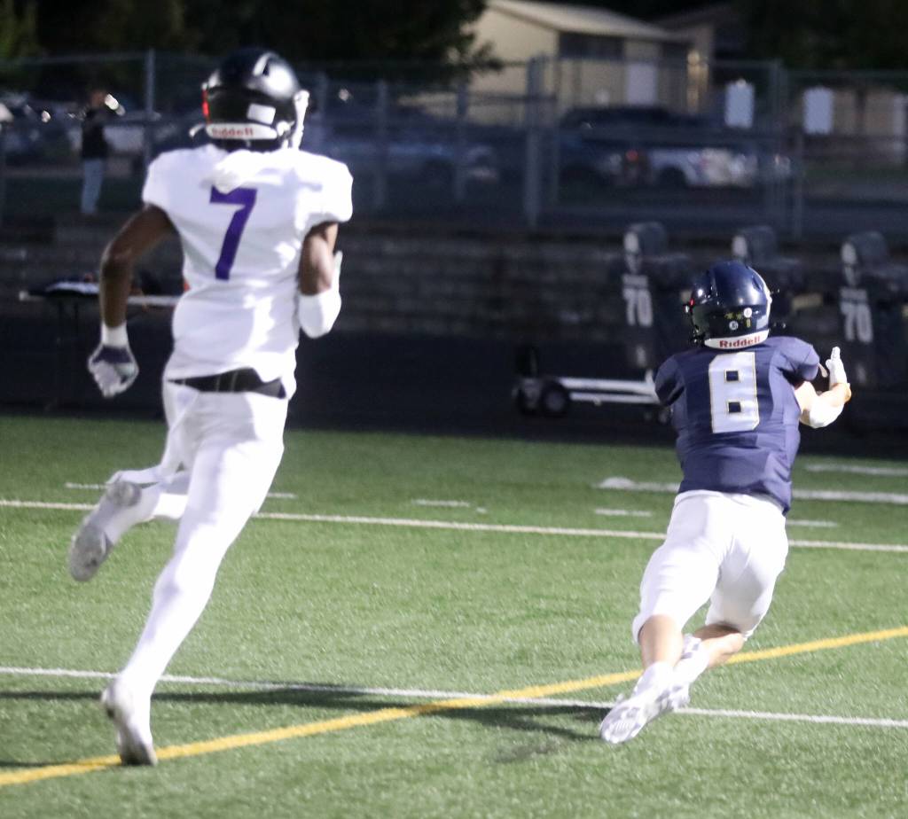 Arlington High School senior wide receiver Kaid Hunter dives to make a catch in the end zone during the Wesco 4A game against Kamiak High School at John C. Larson Stadium, in Arlington, Washington, on Sept. 27, 2024. Arlington won 52-7. (Taras McCurdie / The Herald)