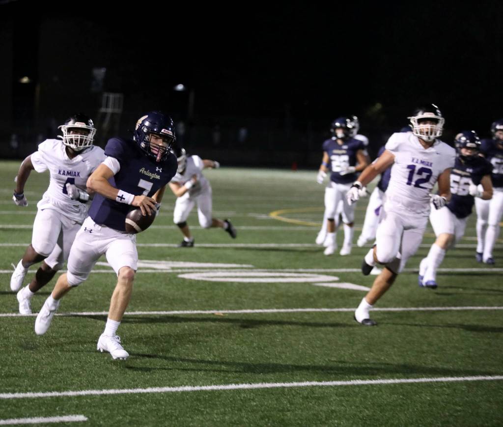 Arlington High School senior quarterback Leyton Martin runs toward the end zone during the Wesco 4A game against Kamiak High School at John C. Larson Stadium, in Arlington, Washington, on Sept. 27, 2024. Arlington won 52-7. (Taras McCurdie / The Herald)