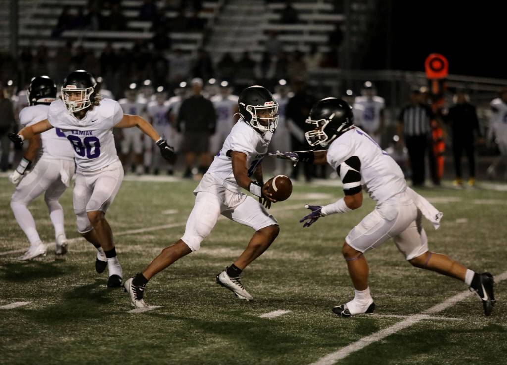 Kamiak High School senior quarterback Ashton Smiles hands off the football during the Wesco 4A game against Arlington High School at John C. Larson Stadium, in Arlington, Washington, on Sept. 27, 2024. Arlington won 52-7. (Taras McCurdie / The Herald)