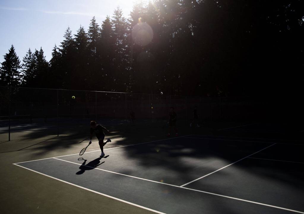 Jackons Samuel Song scrambles after the ball during a doubles match against Kamiak on Monday, Sept. 30, 2024 in Mill Creek, Washington. (Olivia Vanni / The Herald)
