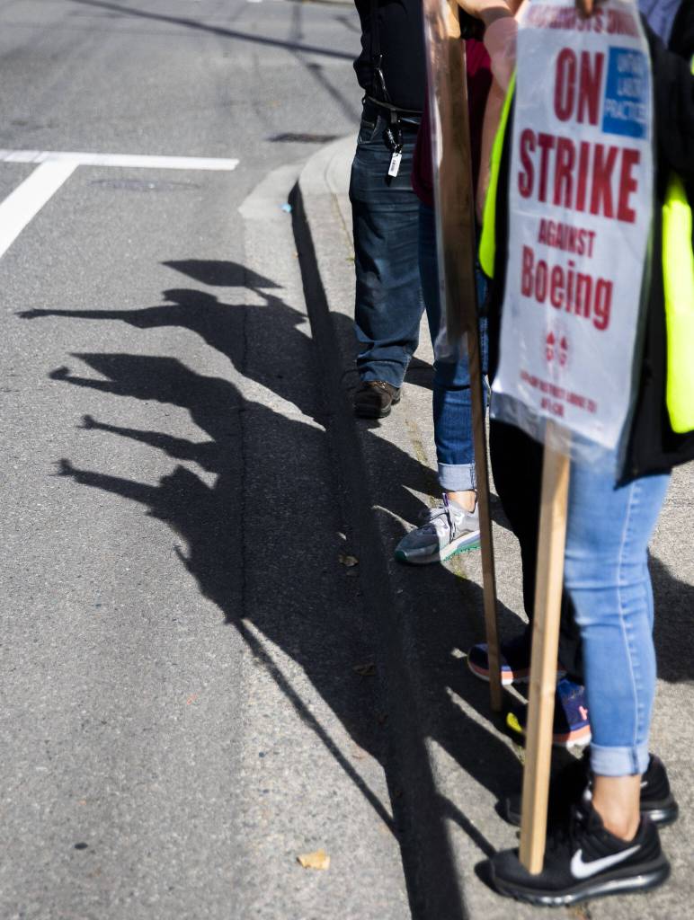 Boeing workers shadows are cast along Airport Road on Tuesday, Oct. 1, 2024 in Everett, Washington. (Olivia Vanni / The Herald)