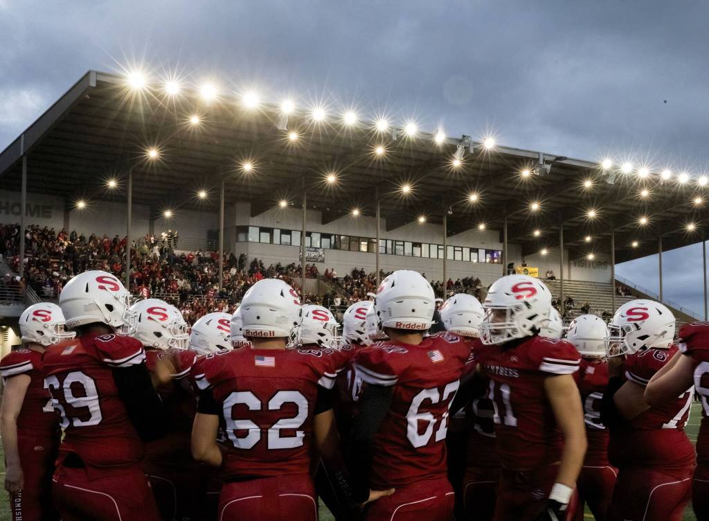 Snohomish players gather for a pep talk before the start of the game on Friday, Oct. 4, 2024 in Snohomish, Washington. (Olivia Vanni / The Herald)