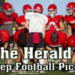 Stanwood's Michael Mascotti relays the next play to his teammates during football practice on Monday, Aug. 29, 2022 in Stanwood, Washington. (Olivia Vanni / The Herald)