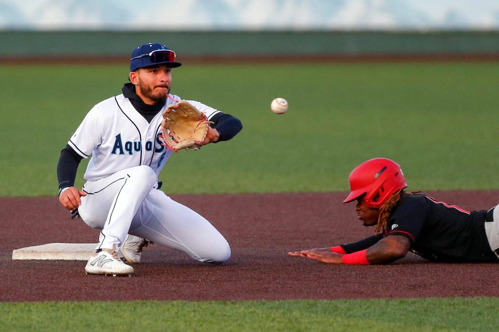 Aquasox shortstop Axel Sanchez tries to tag out a base stealer during a game against the Vancouver Giants on Wednesday, June 5, 2024, at Funko Field in Everett, Washington. (Ryan Berry / The Herald)
