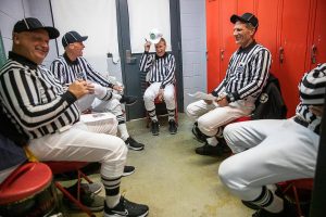 Ross Noe (left to right), Steve Jensen, Tom Freal, Jim Brotten and Dean Corcoran all laugh in the locker room as they get ready to officiate a high school football game on Friday, Oct. 4, 2024 in Snohomish, Washington. (Olivia Vanni / The Herald)