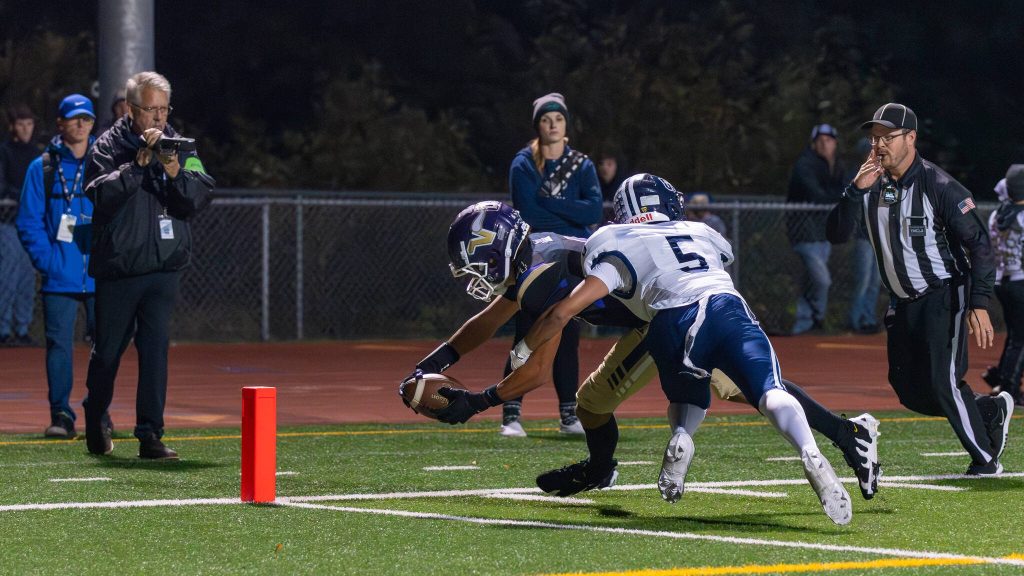 Lake Stevens Seth Price reaches for the goal line as Glacier Peaks Isaiah Olson tries to push him out of bounds during a game in Lake Stevens, Wash., on Friday, Oct. 4, 2024. Price scored on the play. (John Gardner / Pro Action Image)