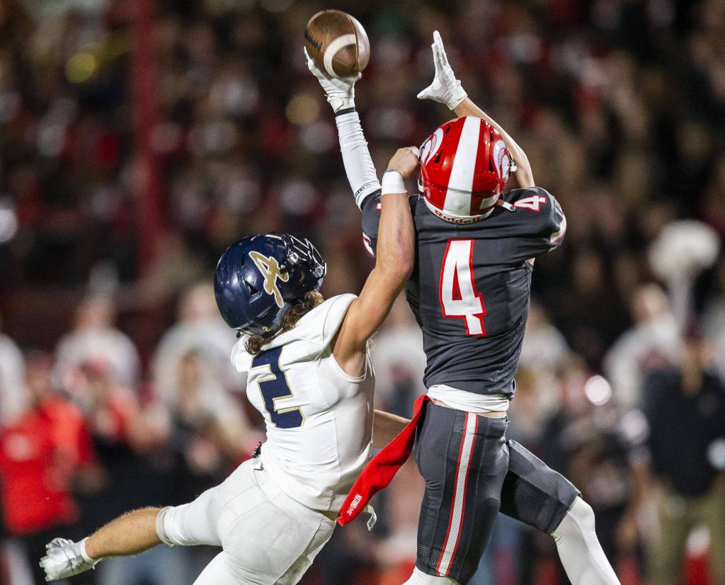 Arlingtons Jake Willis reaches up to block a pass to Stanwoods Preston Turner during the Stilly Cup game on Friday, Oct. 11, 2024 in Stanwood, Washington. (Olivia Vanni / The Herald)