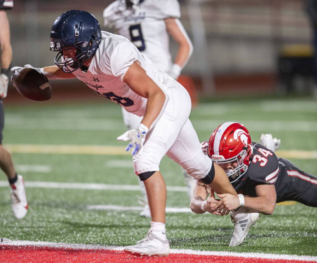 Arlingtons Caleb Reed runs the ball into the end zone for a touchdown during the Stilly Cup game against Stanwood on Friday, Oct. 11, 2024 in Stanwood, Washington. (Olivia Vanni / The Herald)