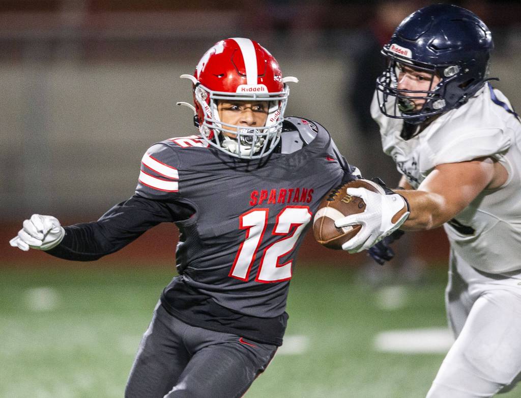 Stanwoods Shawn Porter escapes a tackle while running the ball during the Stilly Cup against Arlington game on Friday, Oct. 11, 2024 in Stanwood, Washington. (Olivia Vanni / The Herald)