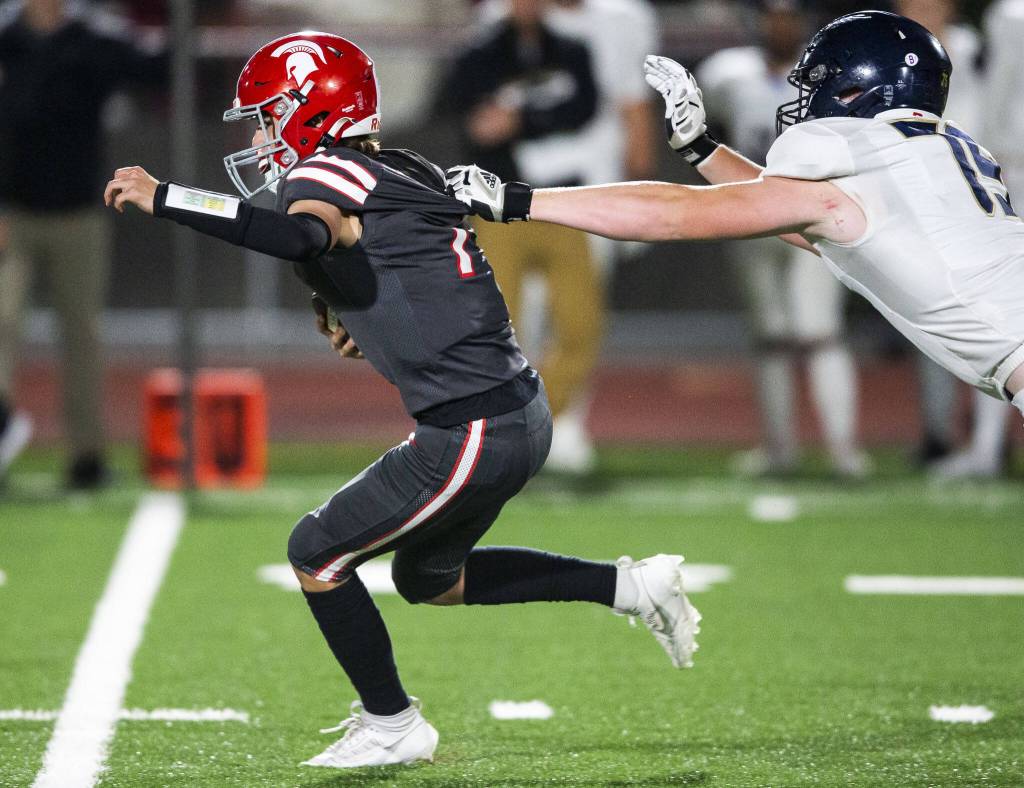 Arlingtons Cooper Case reaches out to try and tackle Stanwoods Alex Maldonado during the Stilly Cup game on Friday, Oct. 11, 2024 in Stanwood, Washington. (Olivia Vanni / The Herald)