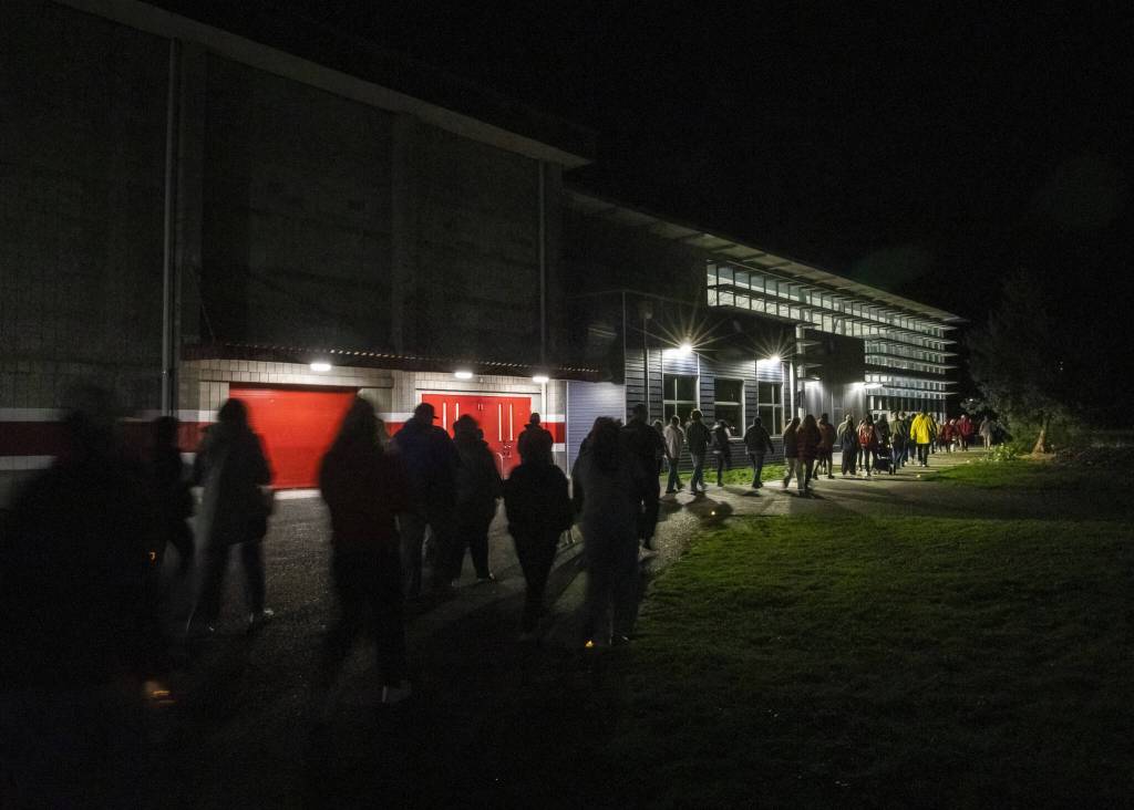 Community members walks past the new cafeteria commons during a memorial walk on the 10-year anniversary of the shooting at Marysville Pilchuck High School on Thursday, Oct. 24, 2024 in Marysville, Washington. (Olivia Vanni / The Herald)