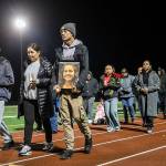 Kordelle Hammond holds a photograph of his cousin Shaylee Chuckulnaskit while her mother Lavina Phillips walks beside him during a memorial walk on the 10 year anniversary of the shooting at Marysville Pilchuck High School on Thursday, Oct. 24, 2024 in Marysville, Washington. (Olivia Vanni / The Herald)