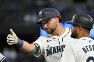 The Seattle Mariners' Cal Raleigh gestures after hitting a single during the second inning against the Cleveland Guardians at T-Mobile Park on Tuesday, April 2, 2024, in Seattle. (Alika Jenner / Getty Images / Tribune News Services)