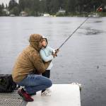Ridley Biggs, 5, right, learns how to cast with her father Mike Biggs as it starts to rain in June 2022 in Lake Stevens. Forecasters predict an atmospheric river could bring as much as 3 to 6 inches of rain for the North Cascades on Friday afternoon into Saturday. (Olivia Vanni / The Herald)