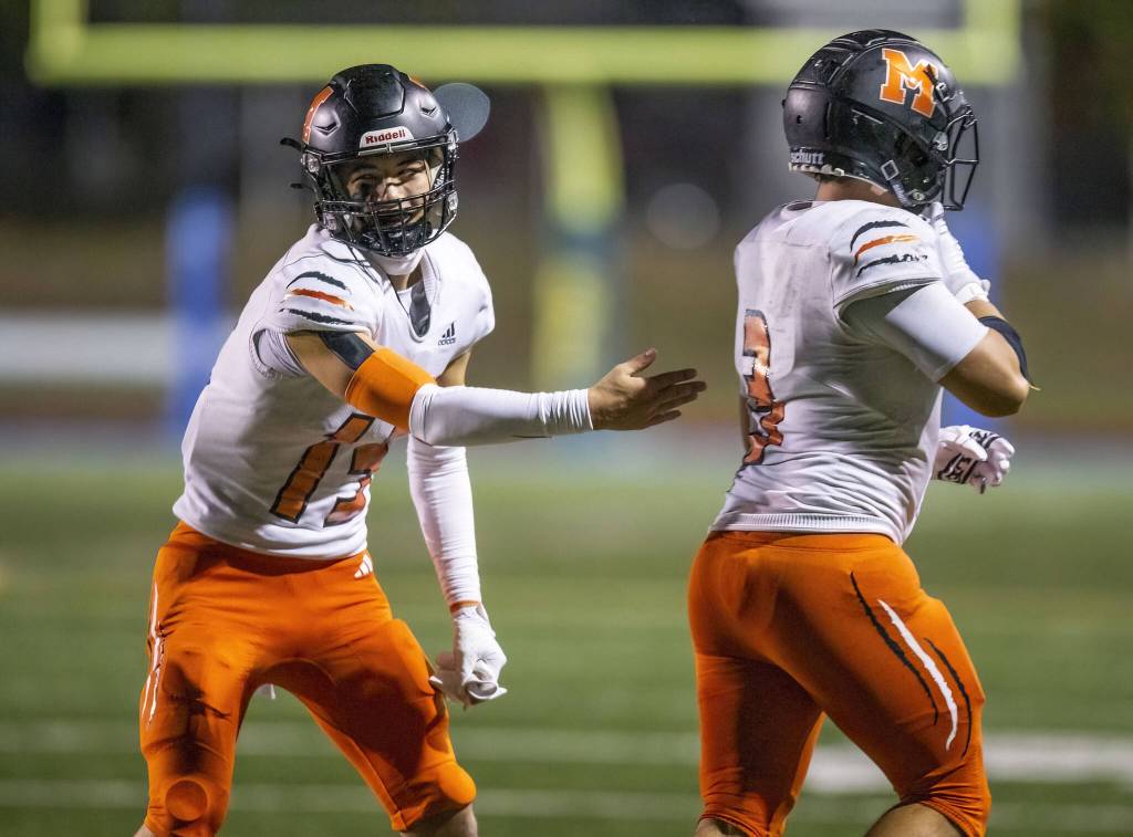 Monroes Zane Osborn congratulates his teammate Aaron Clifton on his touchdown during the game against Shorecrest on Friday, Oct. 18, 2024 in Shoreline, Washington. (Olivia Vanni / The Herald)