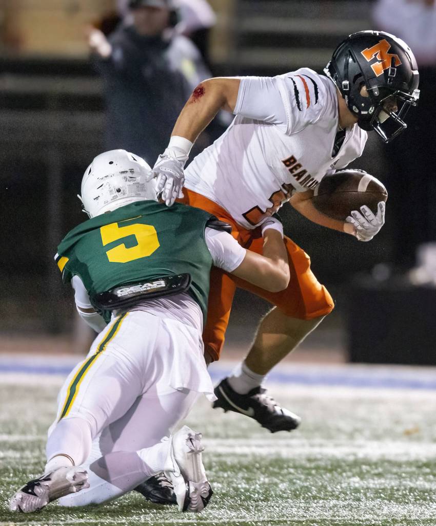 Monroes Aaron Clifton runs through a tackle during the game against Shorecrest on Friday, Oct. 18, 2024 in Shoreline, Washington. (Olivia Vanni / The Herald)