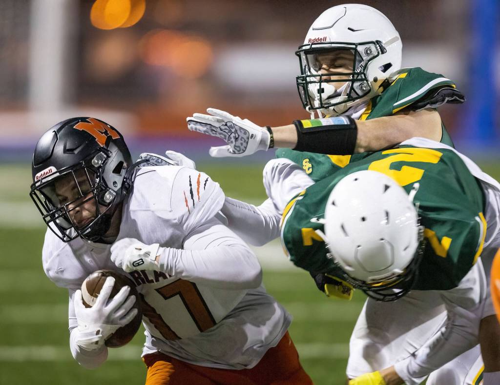 Monroes Jacob Jutte is tackled by multiple Shorecrest players during the game on Friday, Oct. 18, 2024 in Shoreline, Washington. (Olivia Vanni / The Herald)