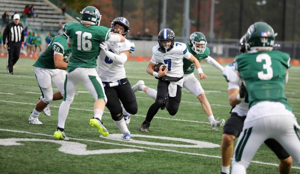 Shorewood senior quarterback Tyler Giles runs with the football during a Wesco 3A South matchup against Edmonds-Woodway in Edmonds, Wash., on Oct. 18, 2024. Shorewood won 31-13. (Taras McCurdie / The Herald)