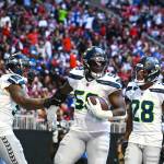 Seahawks linebacker Derick Hall (58) celebrates his fumble return for a touchdown with DreMont Jones (55) and Nehemiah Pritchett (28) against the Atlanta Falcons at Mercedes-Benz Stadium on Sunday, Oct. 20, 2020. (Photo courtesy of the Seattle Seahawks)