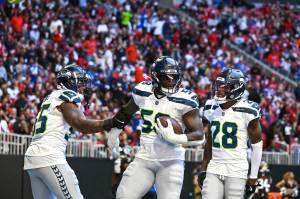 Seahawks linebacker Derick Hall (58) celebrates his fumble return for a touchdown with DreMont Jones (55) and Nehemiah Pritchett (28) against the Atlanta Falcons at Mercedes-Benz Stadium on Sunday, Oct. 20, 2020. (Photo courtesy of the Seattle Seahawks)