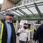 Matt Farnum, center, a machine repair mechanic at Boeing for 14 years, stands outside of Angel of the Winds Arena holding a vote no sign as people file inside to vote on the proposed contract on Wednesday, Oct. 23, 2024 in Everett, Washington. Ill be voting no until the collective approves the contract. Its not just about me its about everyone else, Farnum said. (Olivia Vanni / The Herald)