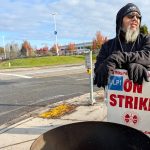 Bubba Chavez talks with other Boeing machinists while picketing outside a company gate on Thursday, Oct. 24, 2024, in Everett, Washington.